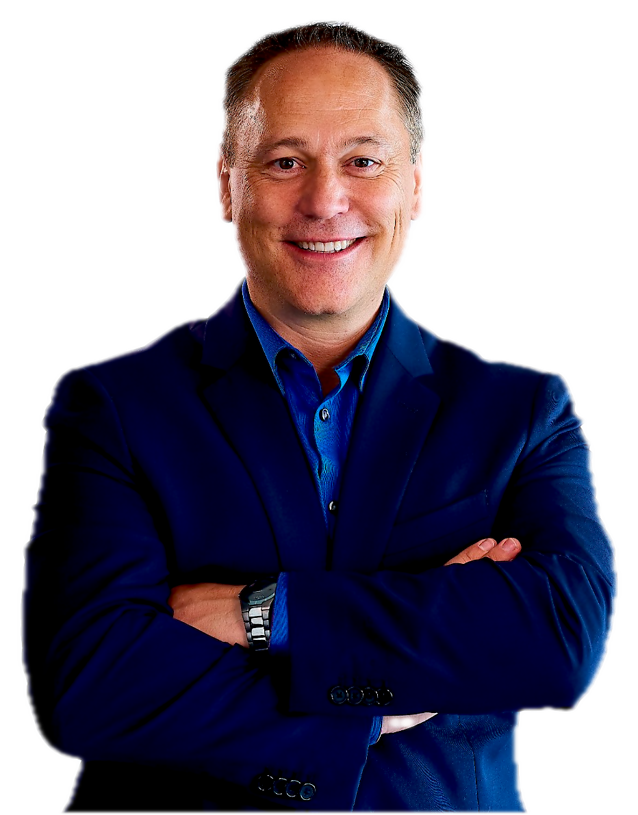 Trevor McGregor, smiling with arms crossed, in a navy suit and blue shirt